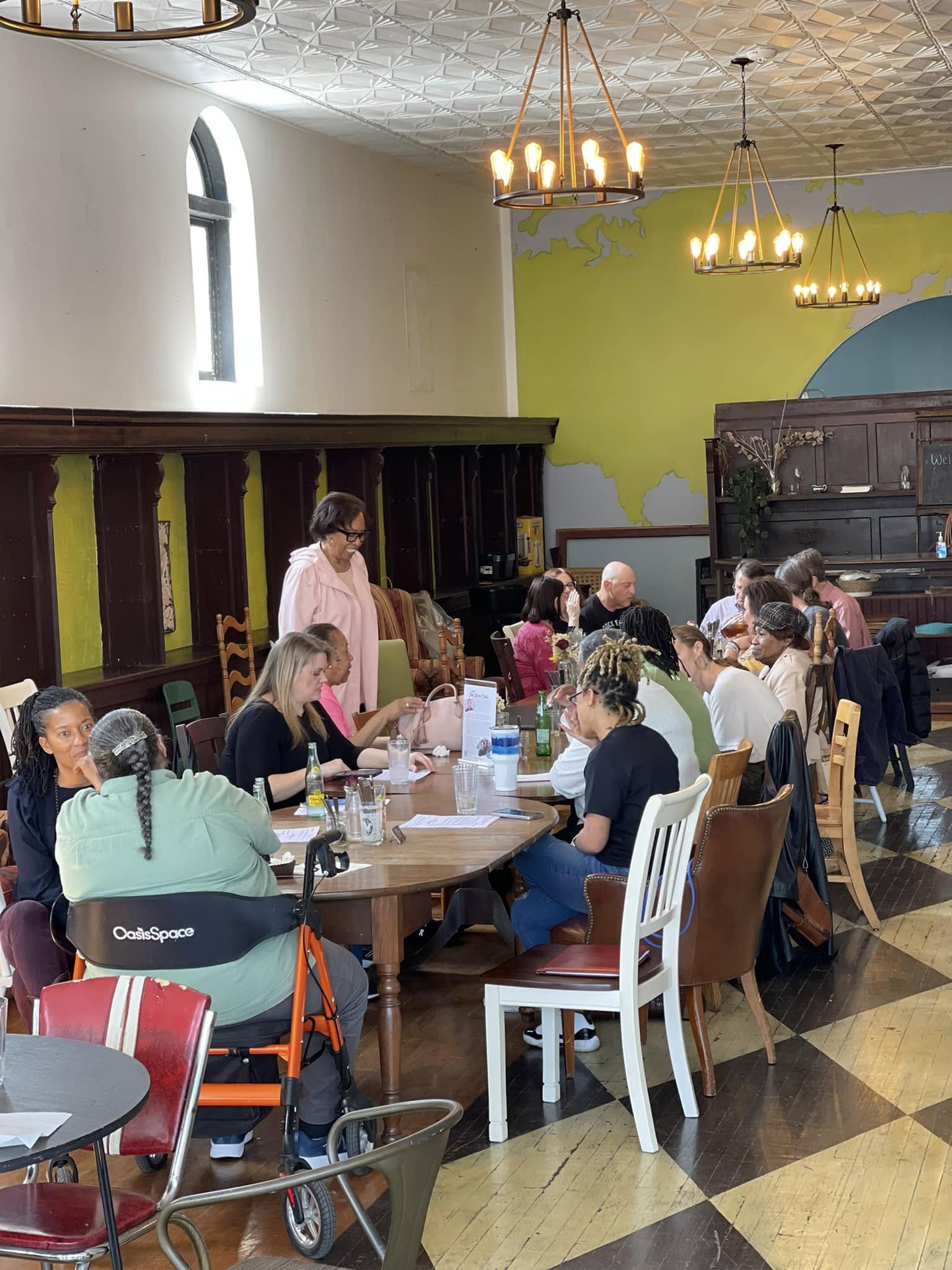 Several people sitting family style at a restaurant